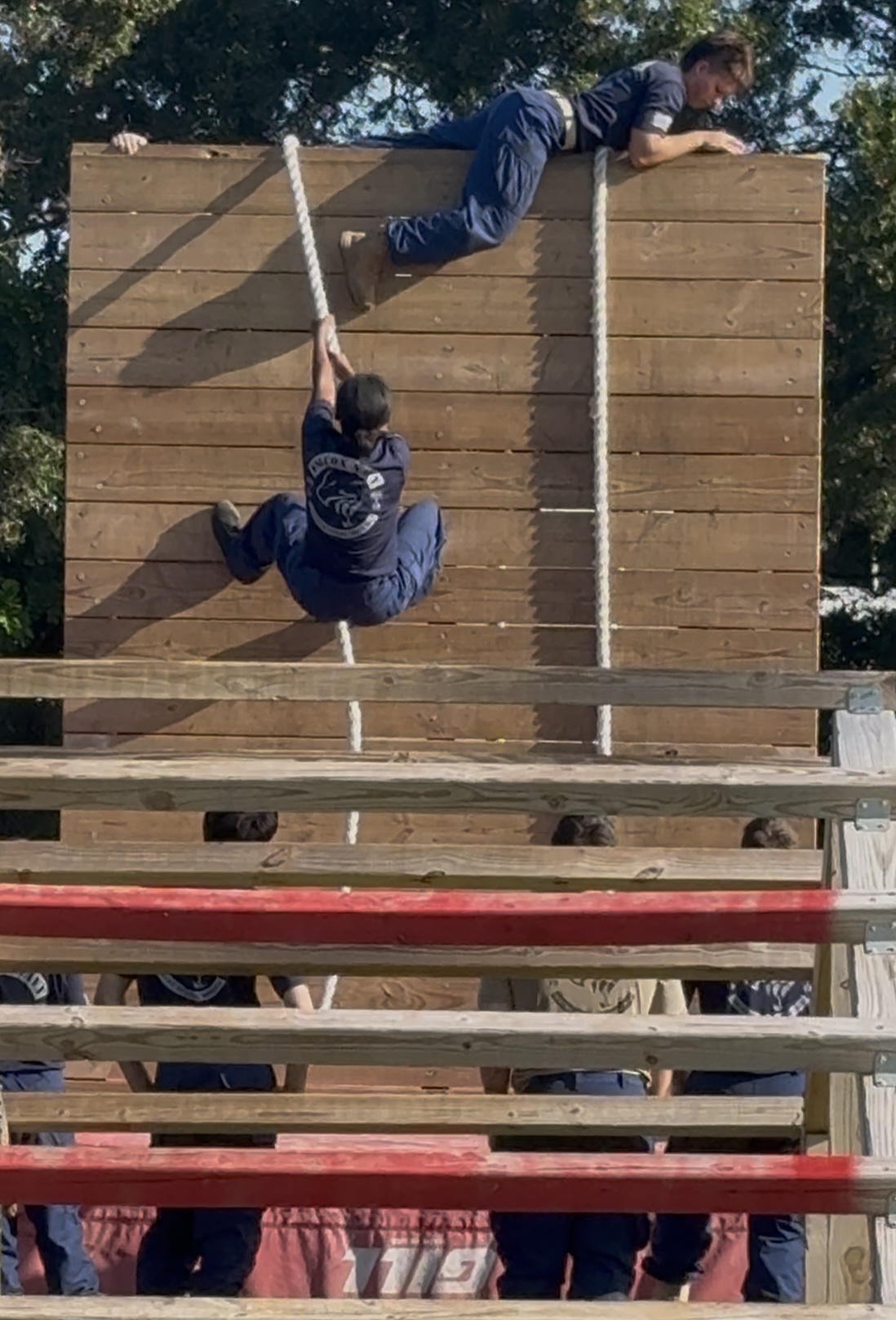 Cadets working together to climb a training wall